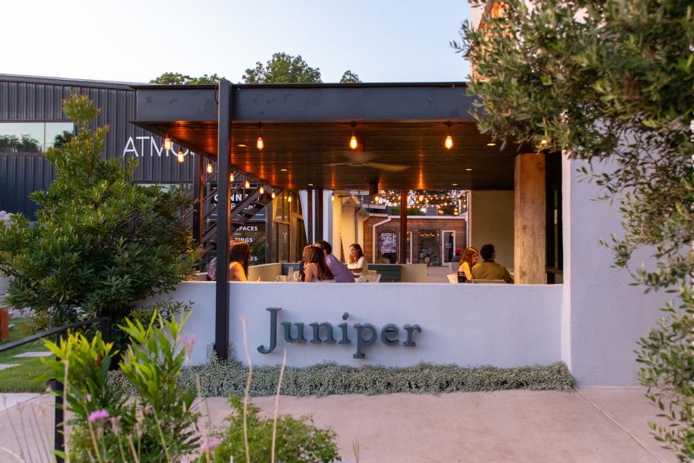 People dining on the patio at Juniper restaurant in Austin Texas