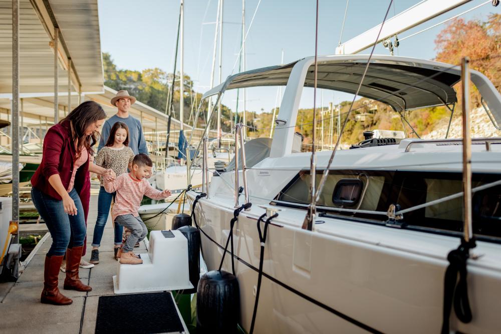 family gets on boat at lakeway resort in austin texas