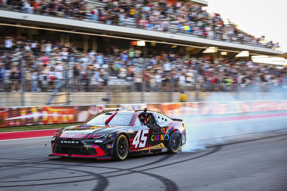 Photo of a car speeding down the track at Circuit of The Americas.