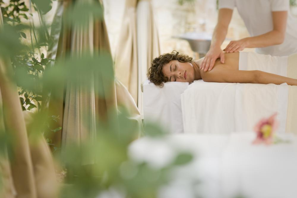 Woman receives massage in Outdoor Treatment Space at Lake Austin Spa Resort in Austin Texas