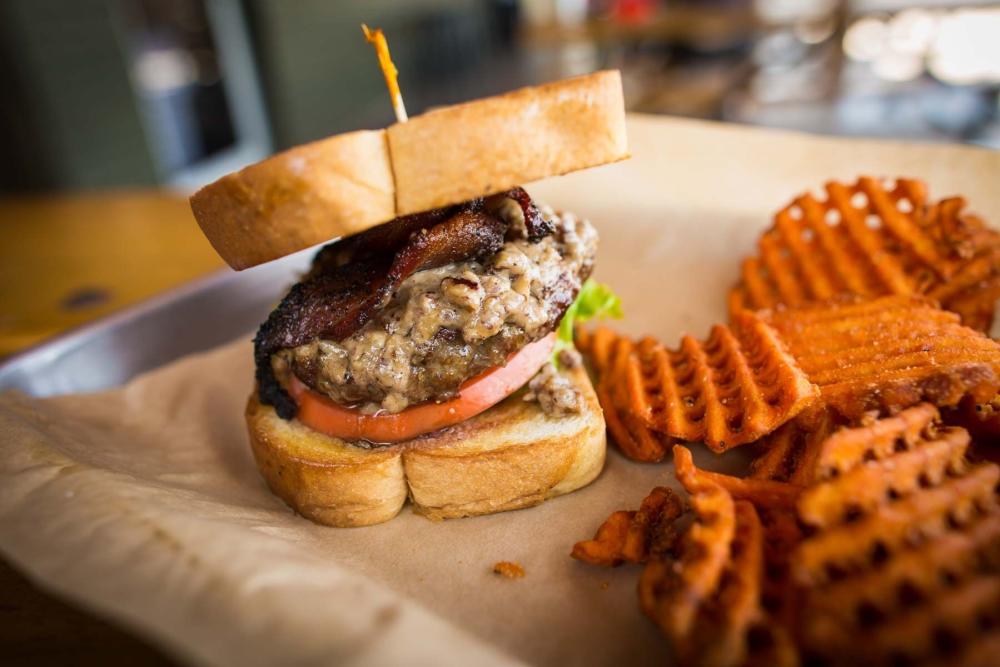 Diner tray with crispy sweet potato waffle fries and thick burger patty on Texas Toast.