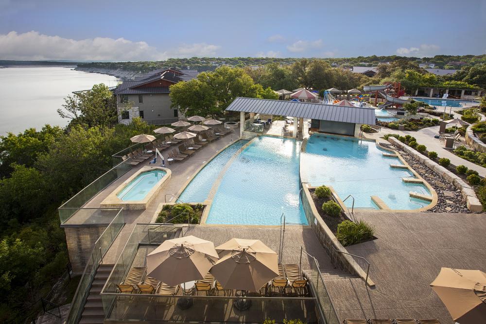 Aerial photo of the pool complex overlooking lake travis at Lakeway Resort in Austin Texas