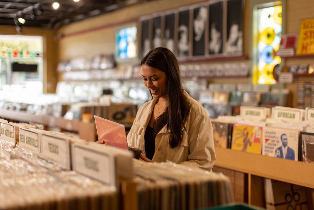 Woman flips through stack of records at Breakaway Records store