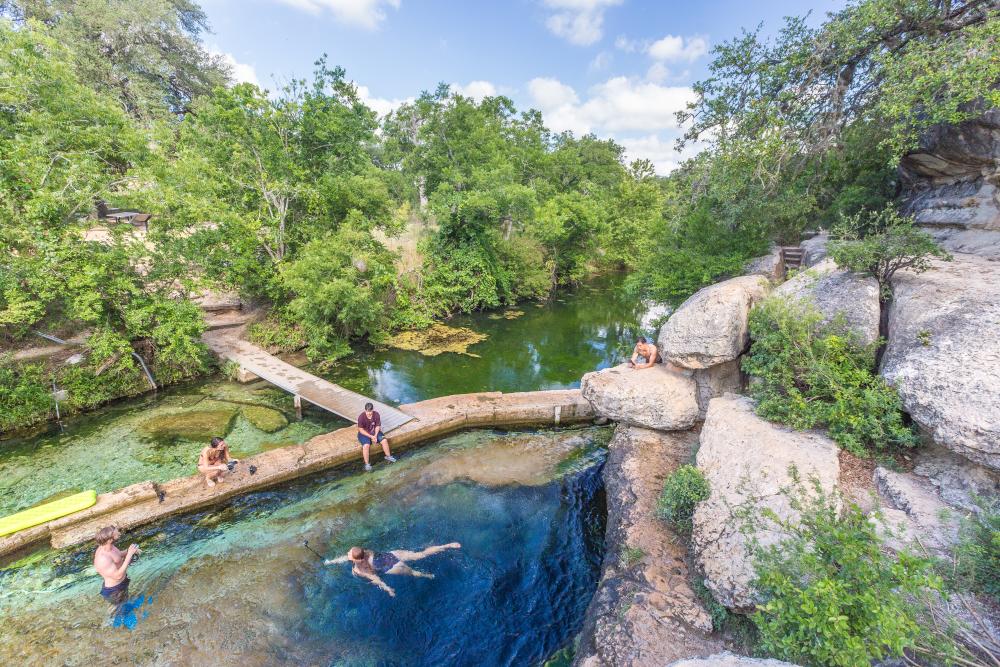 people swimming at Jacobs Well in Wimberley Texas near Austin