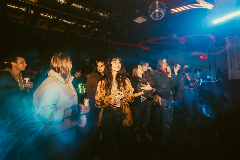 Crowd enjoying live music in a full venue.