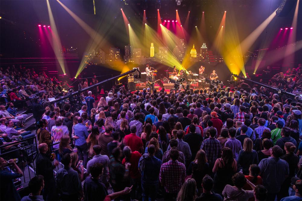 Crowd of people on the bottom level of ACL Live at the Moody Theater, watching a performance of an ACL Live TV show taping.