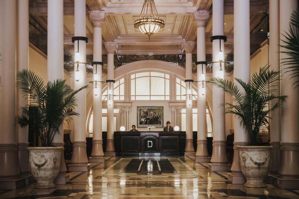 Photo of the grand marbled front entry hall of the Driskill Hotel.