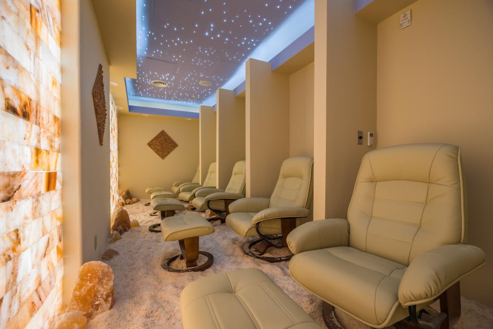 Salt therapy room at Kalahari Resort in Round Rock with plush chairs lined up in front of a salt wall
