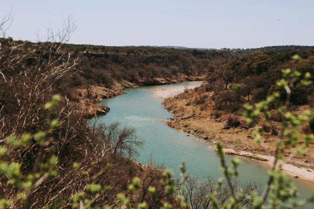 View of winding river and greenery-covered banks at Reimers Ranch.