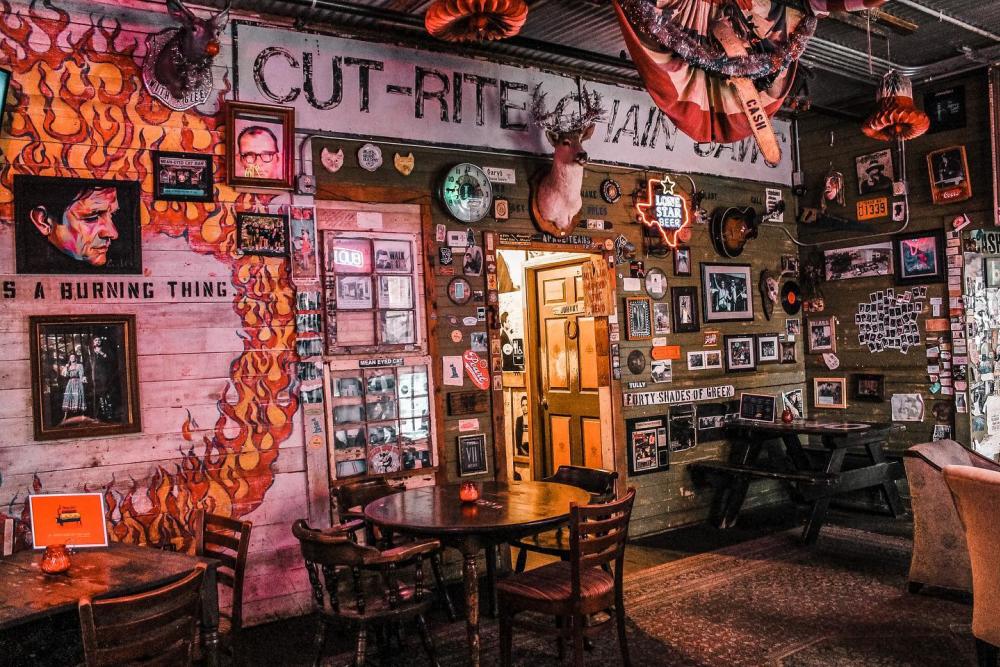 Johnny Cash themed bar with taxidermy, old pictures and murals painted on the wall.