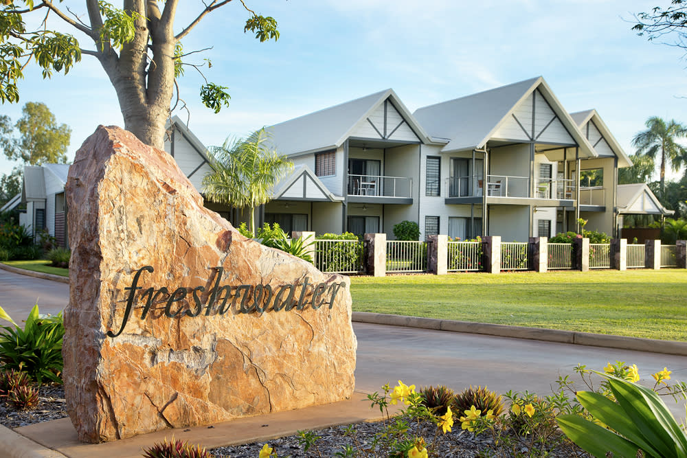View of the entry to Freshwater East Kimberley Apartments in Kununurra, with some of the apartments visible in the background