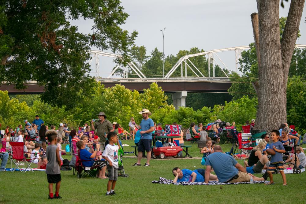 Several Families Enjoying Picnics at Fisherman's Park During the Bastrop Patriotic Festival