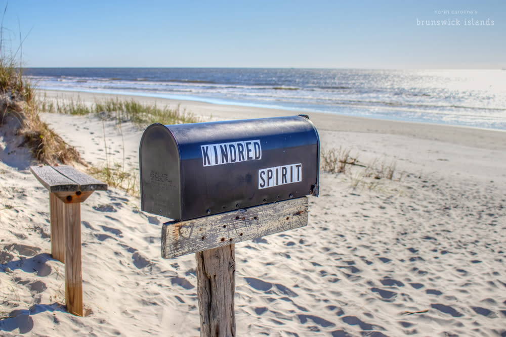 mailbox and a wooden bench on the beach