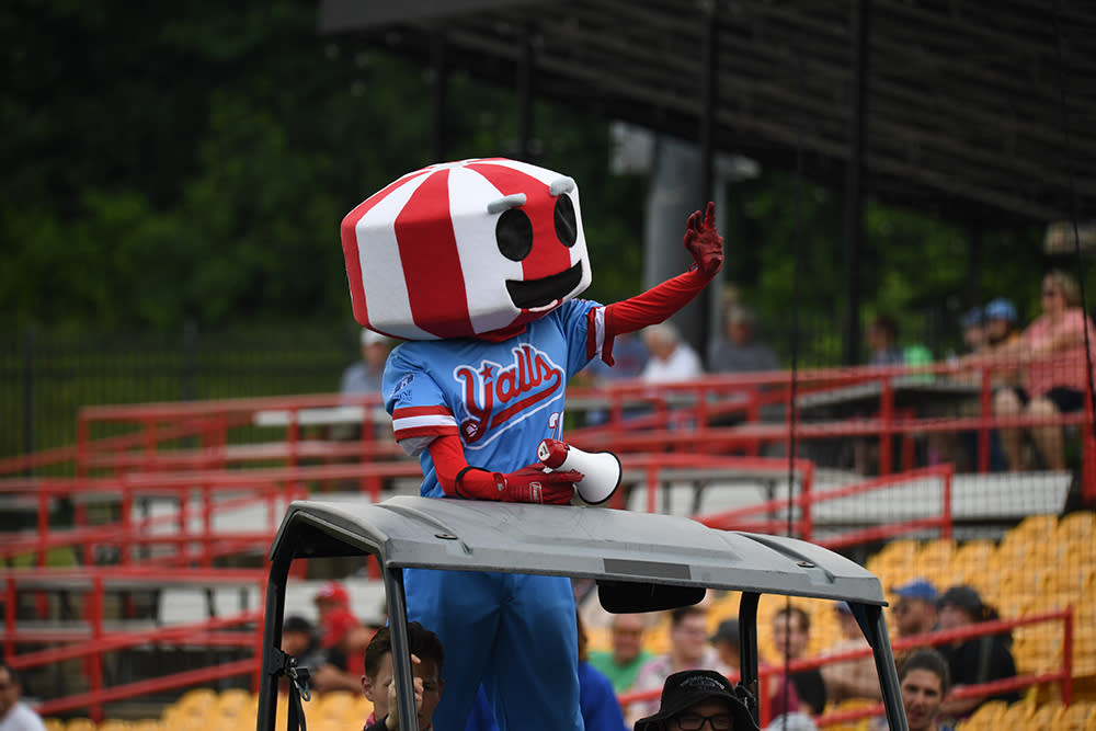 The Florence Y'alls red-and-white striped water tower mascot Y'all Star waves at baseball crowd