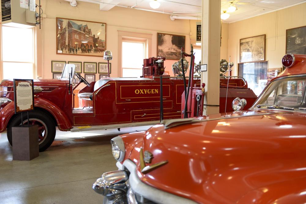 historic fire trucks parked inside at the Fort Wayne Firefighters Museum in downtown fort wayne