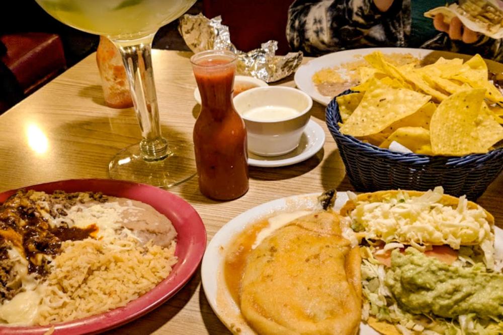 A table of dinner plates and chips and salsa at Mi Pueblo
