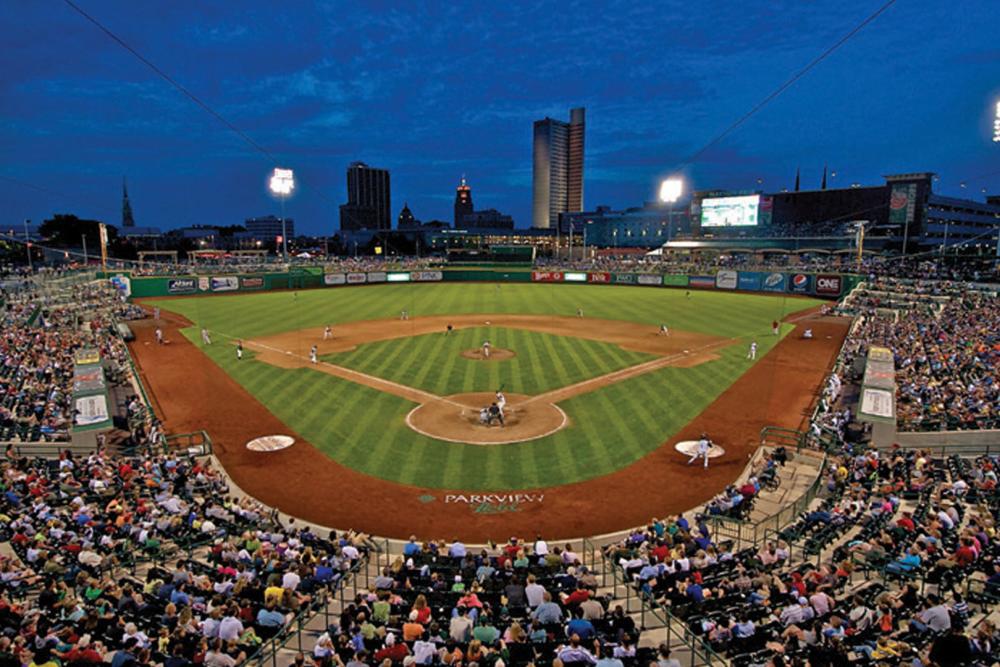 The TinCaps playing baseball in Parkview Field with the Fort Wayne, Indiana skyline in the background.
