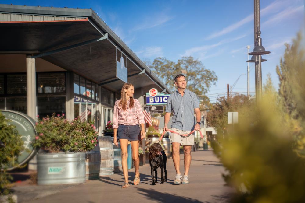 People walking dog along Fredericksburg's Main Street