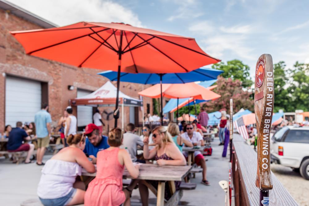 People on the outside patio at Deep River Brewery in Clayton NC.