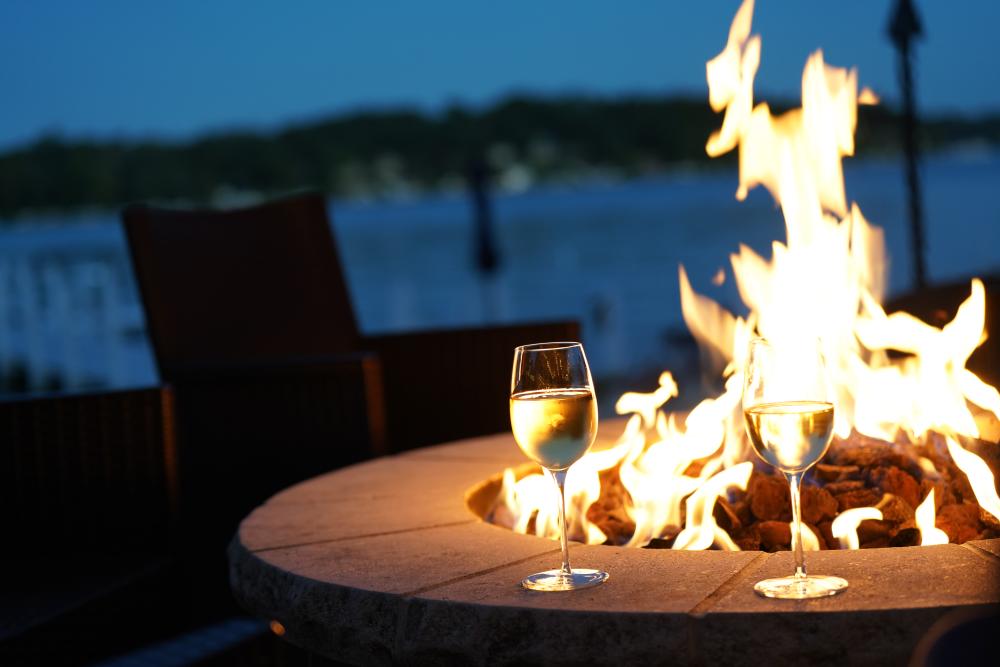 Glasses of wine by a fire pit