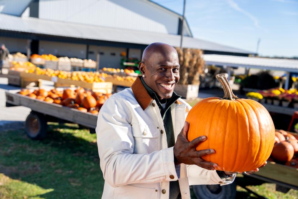 Donald Drive holding a pumpkin at the Pearce's Farm Stand.