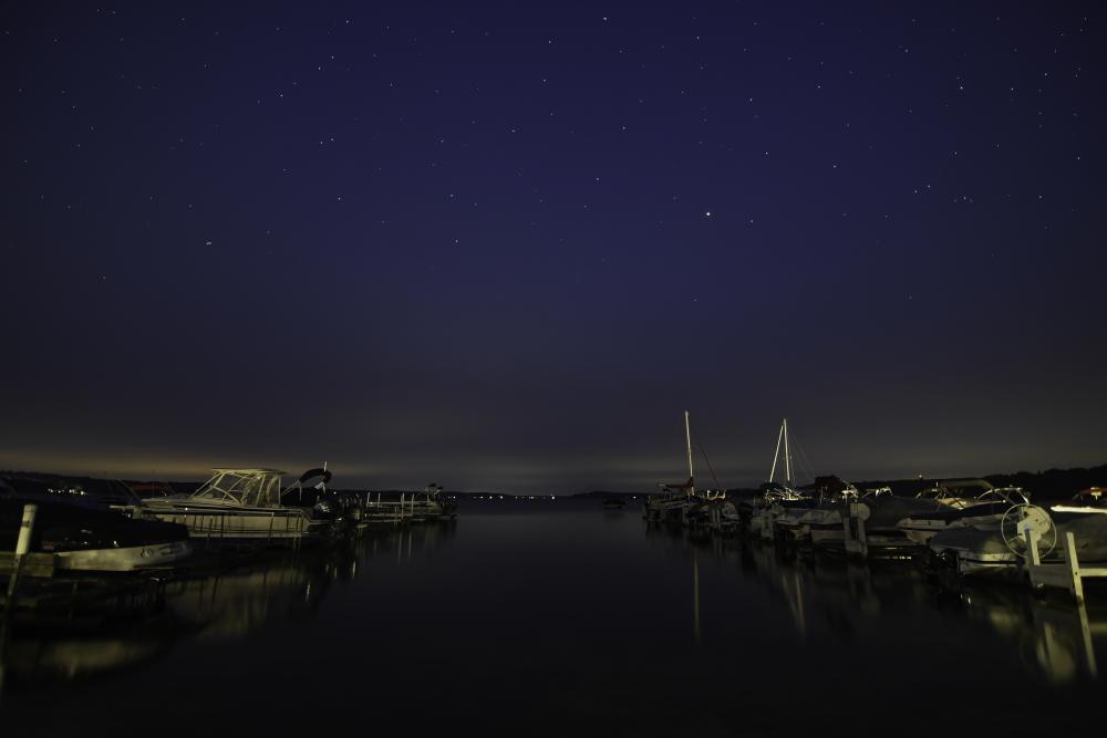 Geneva Lake under the stars with boats and calm waters