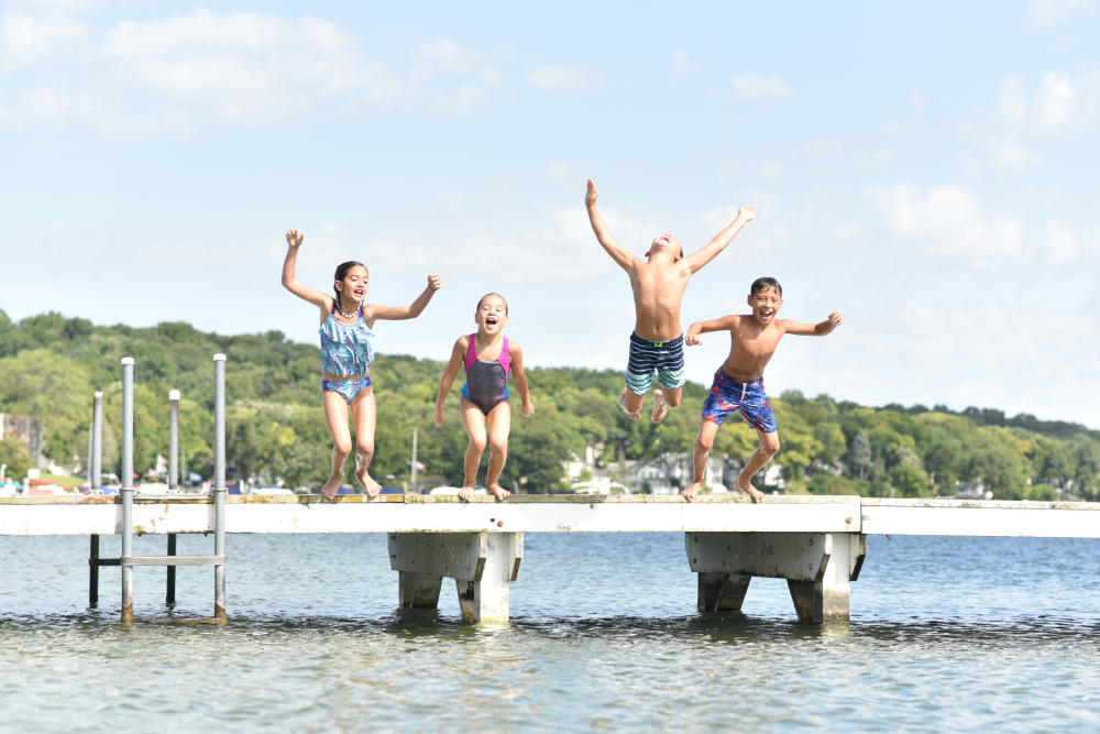 A group of kids jumping off the pier at Riviera Beach