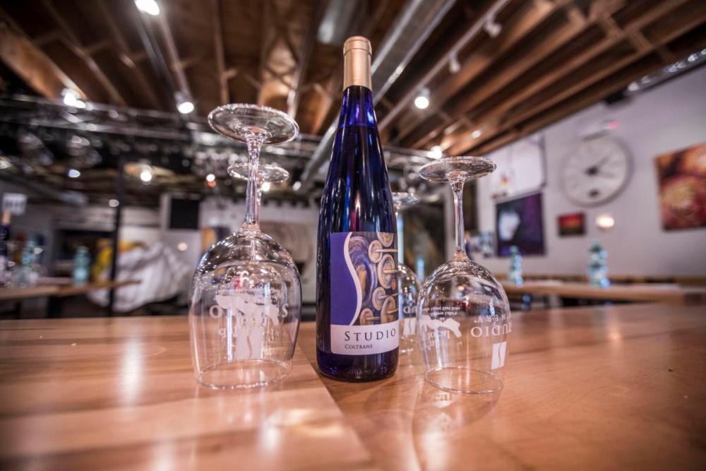 Wine bottle and glasses at Studio Winery