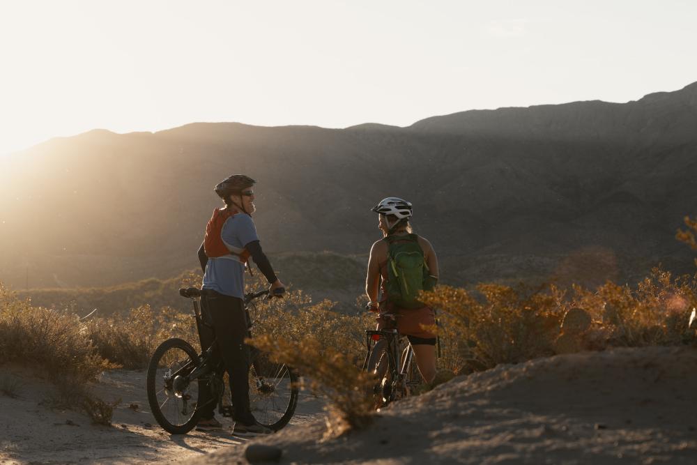 Man and woman mountain biking at dusk near Truth or Consequences, New Mexico