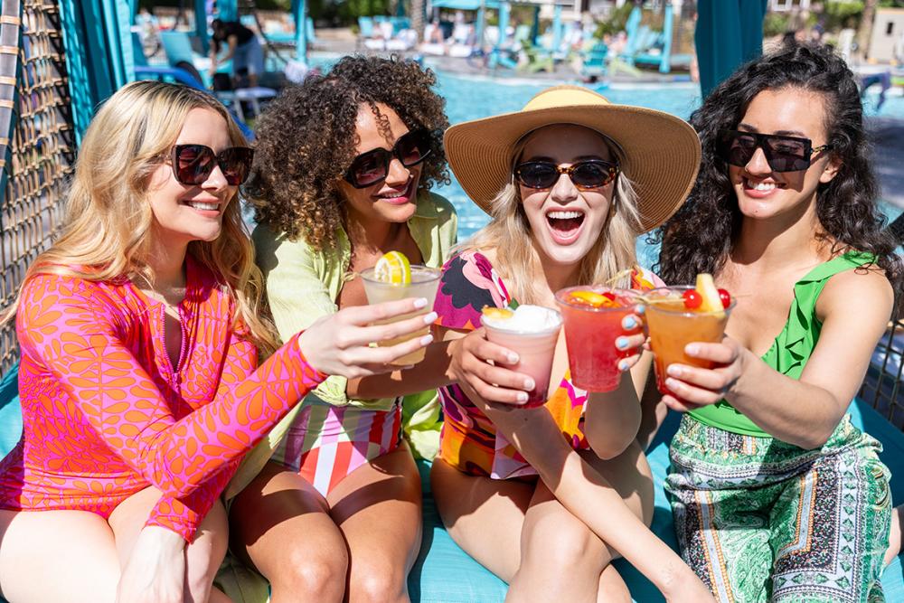 Girls toasting in a cabana by a Palm Springs pool