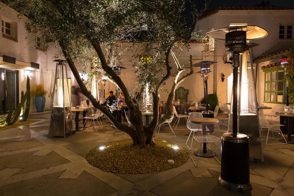 Workshop Kitchen & Bar outdoor patio lit up at night.