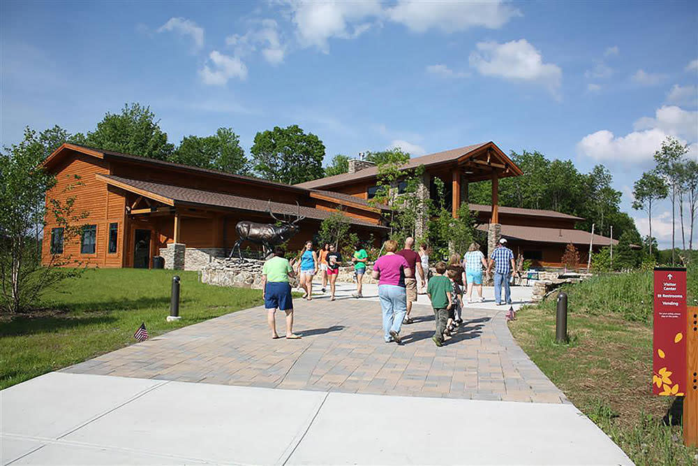 Tourists walking toward Elk Country Visitor Center