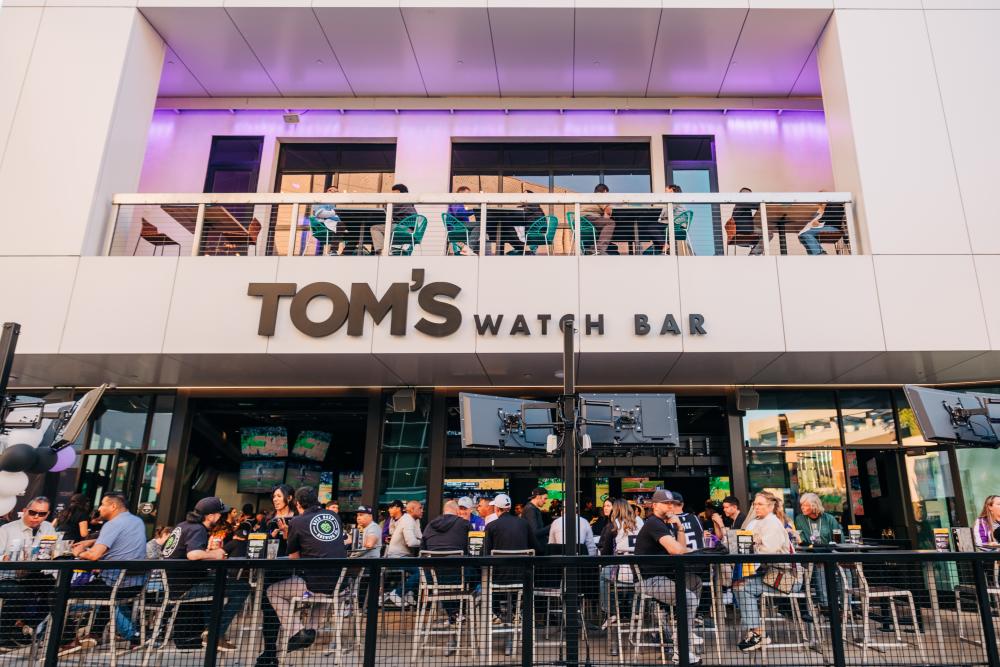 People watching a sports game at Tom's Watch Bar in DOCO