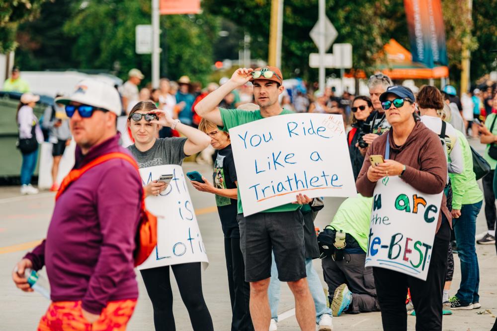 People cheering on athletes finishing IRONMAN California