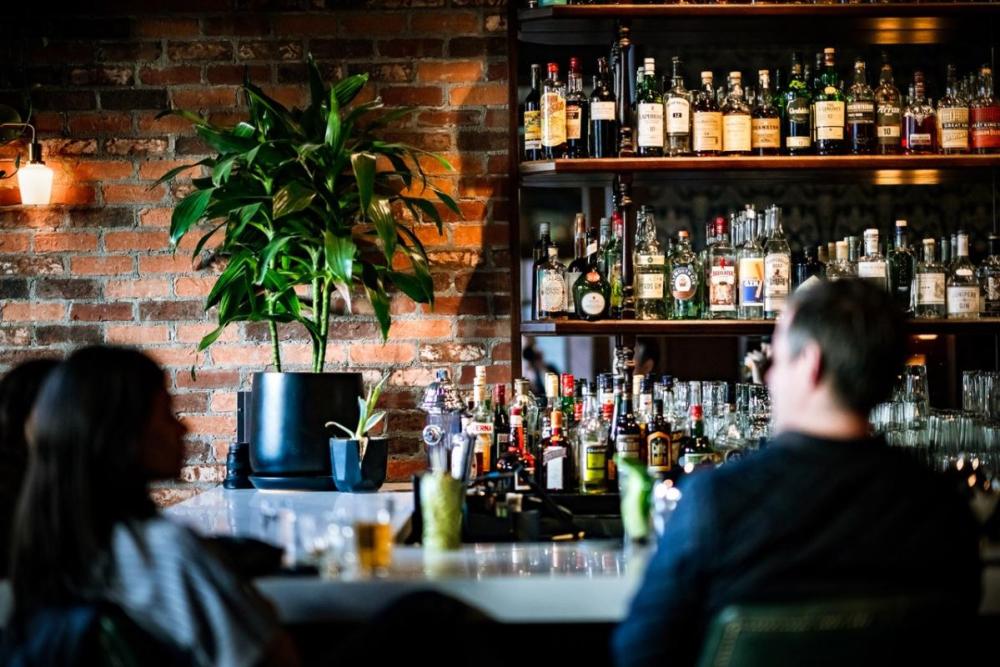 People sitting at the bar at The Snug in Midtown Sacramento.