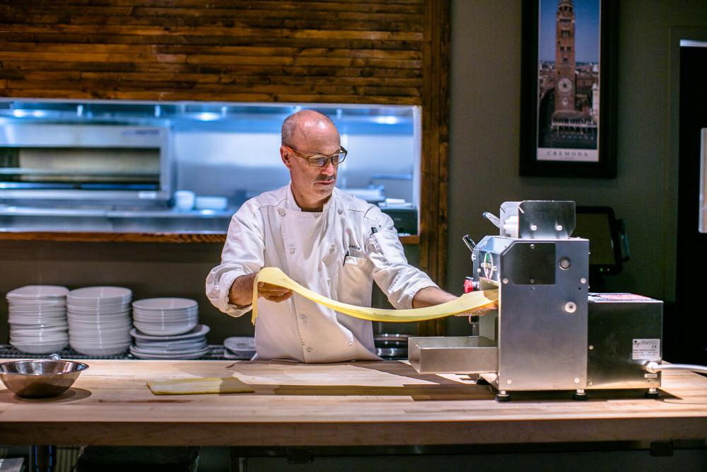 Pasta being pressed in front of guest at il Giallo in Sandy Springs, Georgia