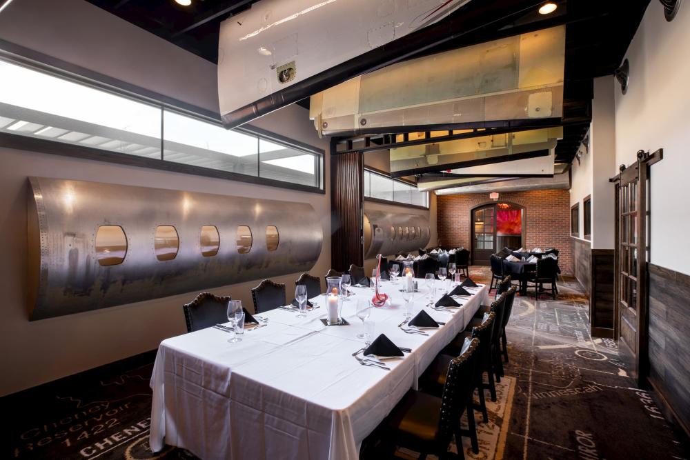 The Aviation Room at Scotch and Sirloin sits empty with the tables set and new aviation decor on display