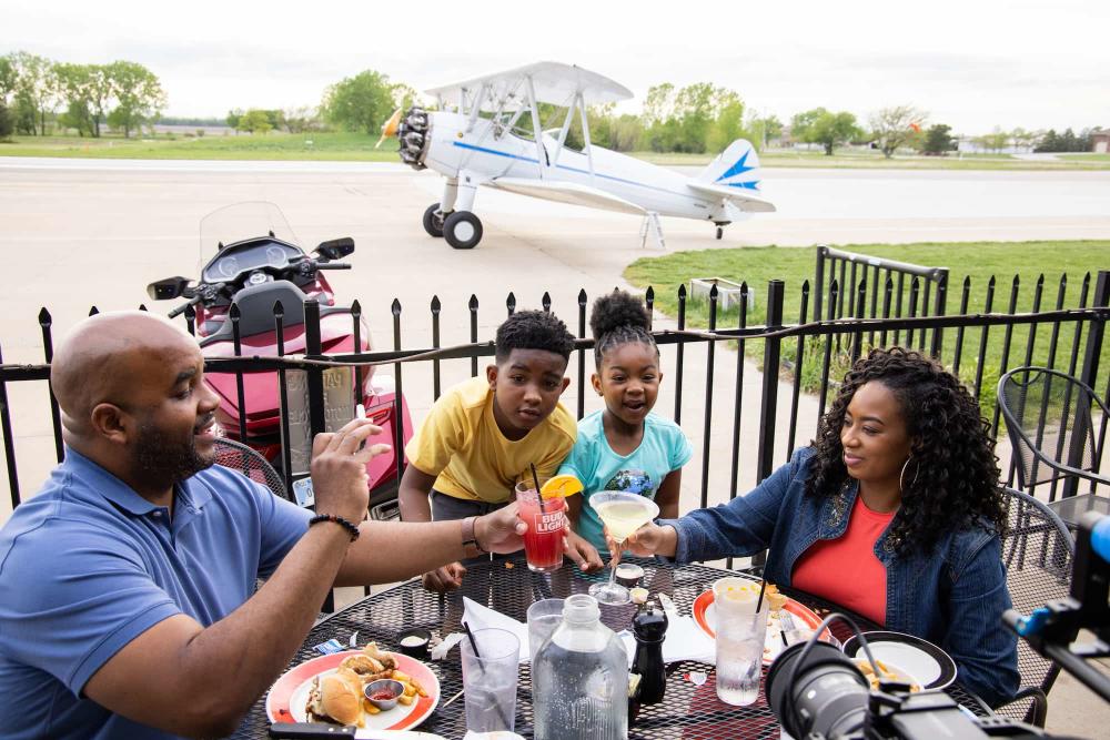 A Family Enjoying Dinner at Stearman Field Bar and Grill In Wichita, KS