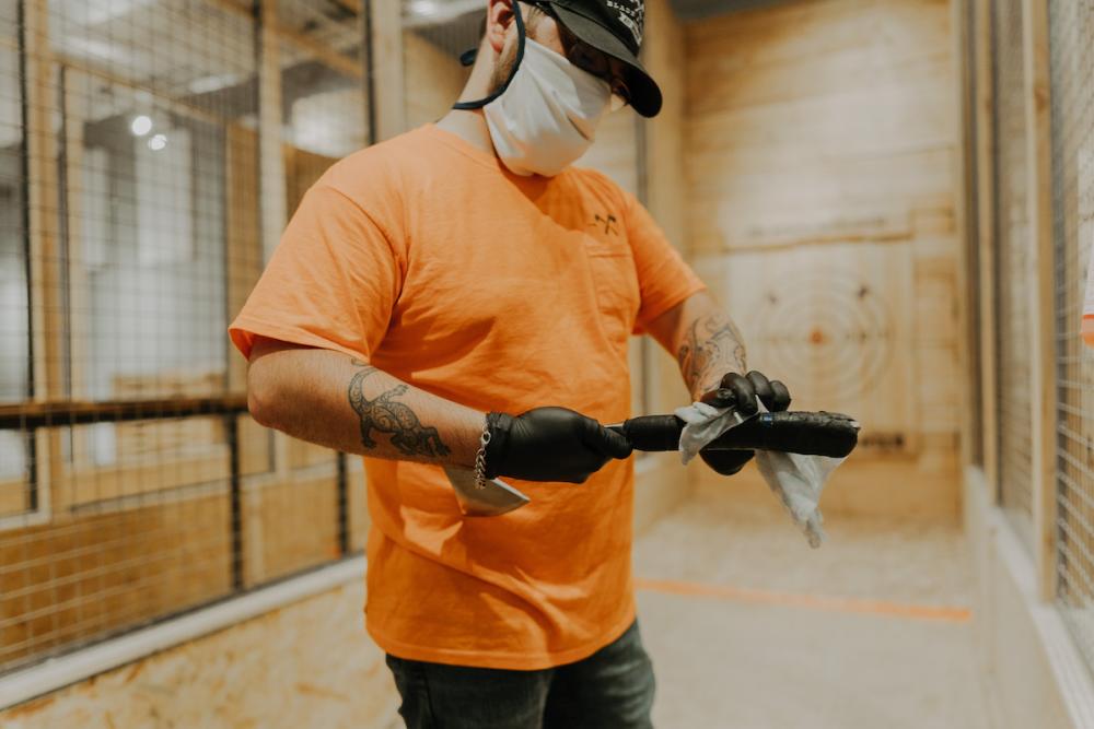 Blade and Timber Coach Wearing Mask and Sanitizing Axes