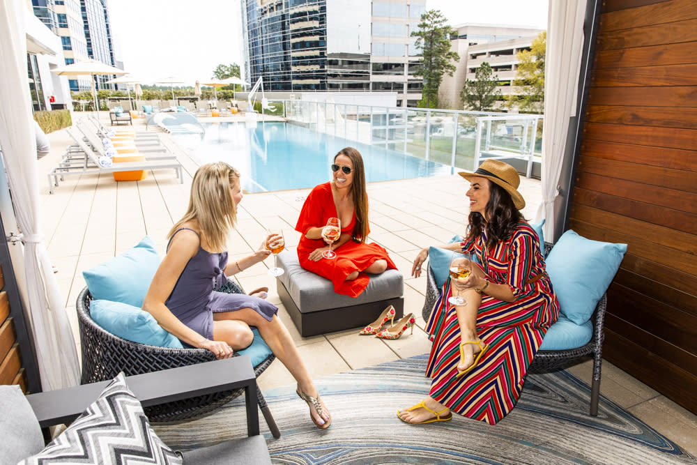 Women sitting in a cabana at the rooftop pool