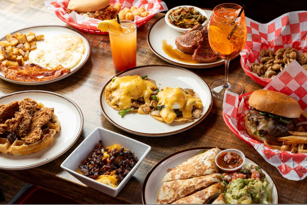 A catering spread from Lankford's, including eggs benedict, pork chops, burgers, quesadillas, fried chicken and waffles, and more.
