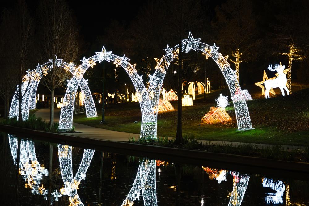 Silver arches lined with stars create a light tunnel along Holiday on The Waterway in The Woodlands, TX.