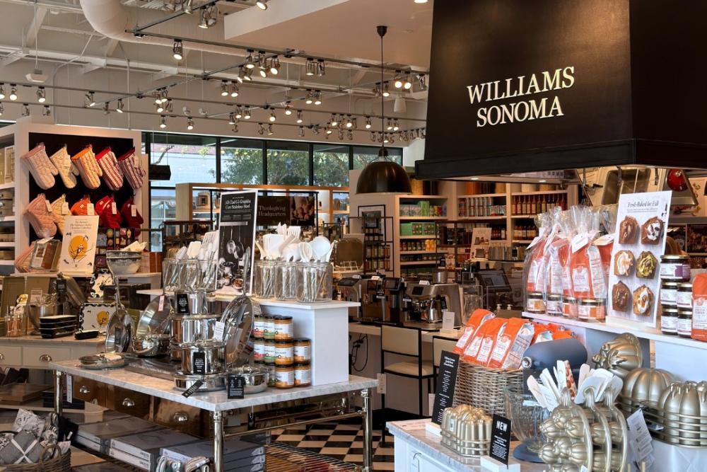 The interior of Williams Sonoma at Hughes Landing is packed with cookware and boutique food items for sale, including stainless steel pans, oven mitts, baking tins, fall bread starters, etc.
