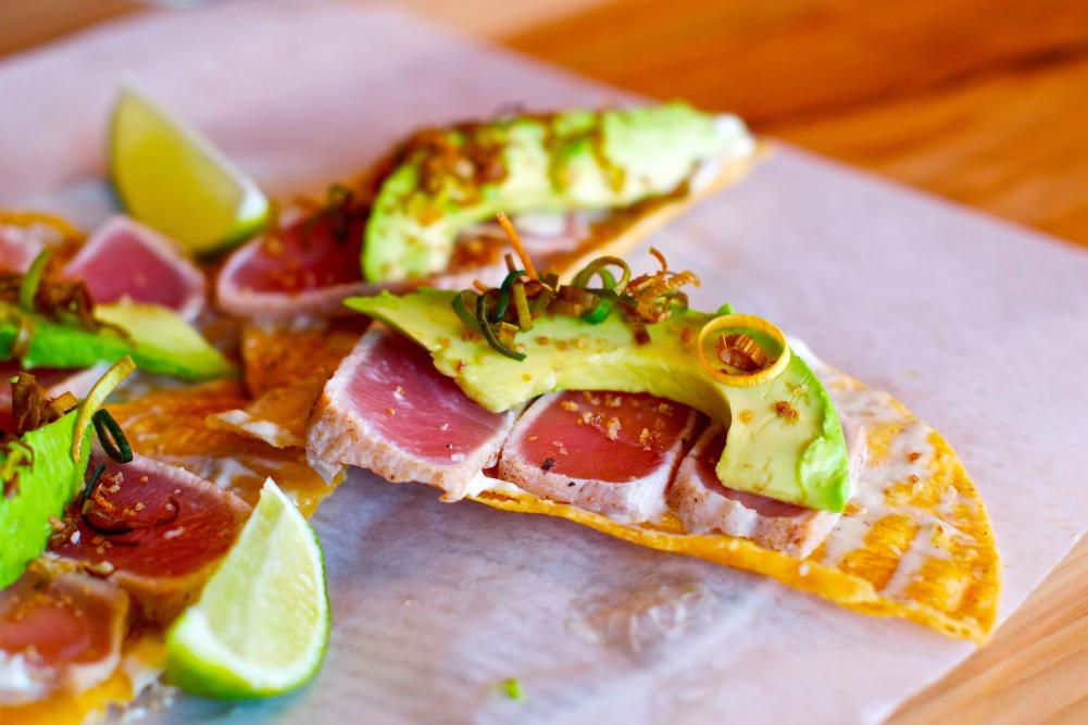 Tacos with avocado and lime wedges Taco Flats