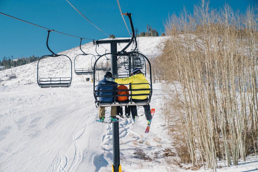 Skiers on chairlift at Granby Ranch