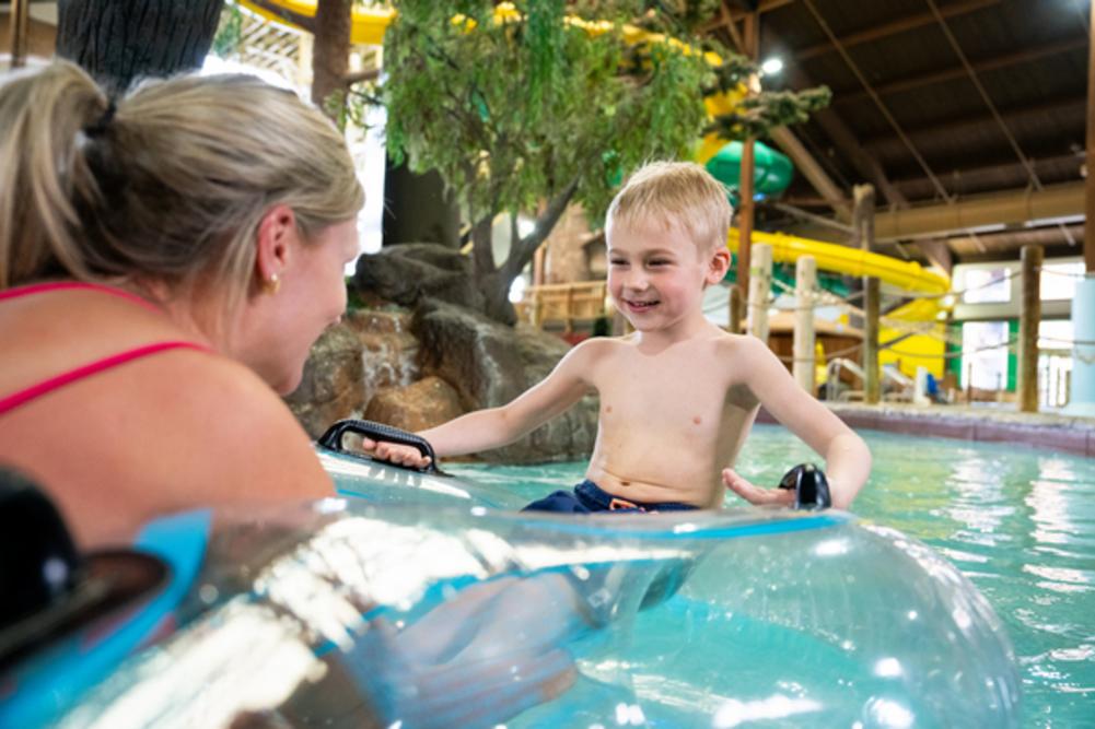 Mom and child in the lazy river at Timber Ridge