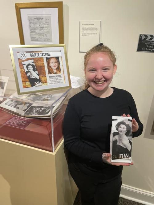 Dominique Benedict holding a bag of the Ava Gardner Goddess Blend Coffee