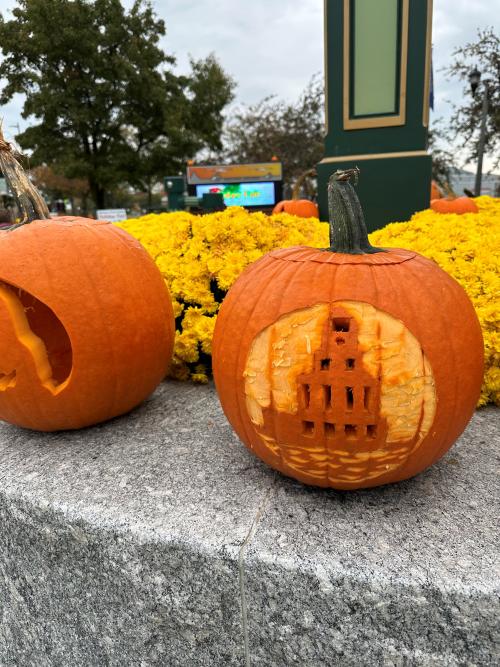 pumpkin on clock tower ledge