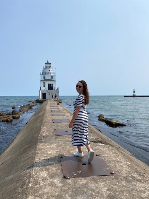 Woman walking out to Manitowoc Breakwater Lighthouse
