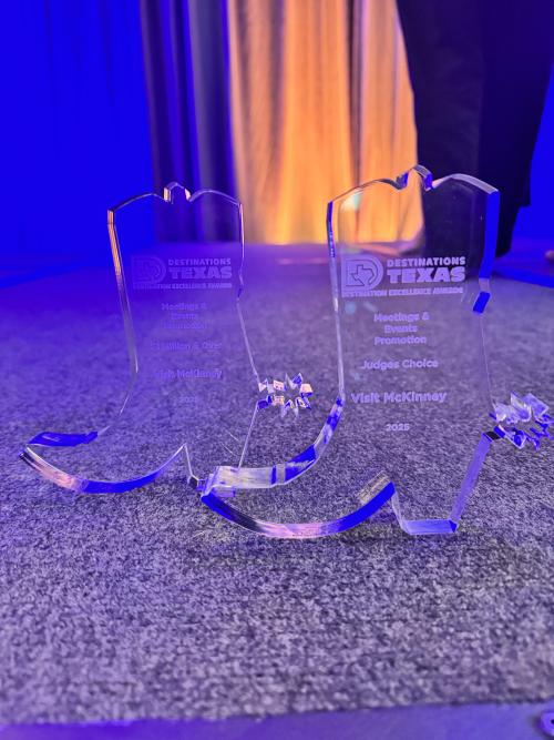 Two clear award plaques in the shape of boots for Best Promotions and Events categories.